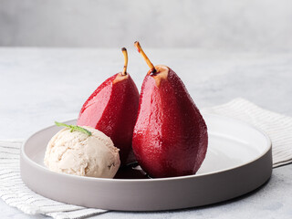 Composition with sweet poached pears and ice cream on light background