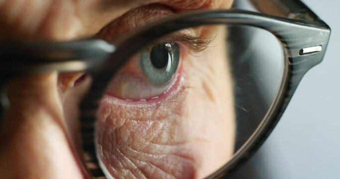 Senior woman face, reading glasses and eyes for vision, thinking and focus eye care. Zoom macro on elderly grandma skin, retirement age and healthy eye care, optometry test and human perception idea