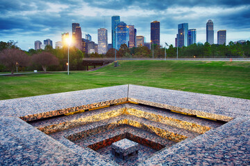 Downtown Houston from Police Memorial park at dramatic sunset. Green park lawn and modern skylines....