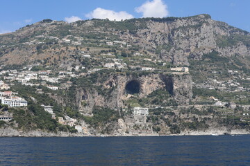 Scenic view from the sea to the castle near big natural cave in Amalfi Coast, Italy.