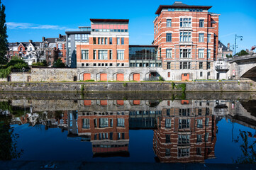 Namur, Wallon Region, Belgium, Historical buildings reflecting in the blue water of the River Sambre