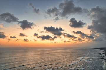 Fototapeta na wymiar Beautiful red orange sunset sunrise over the ocean sea with waves 