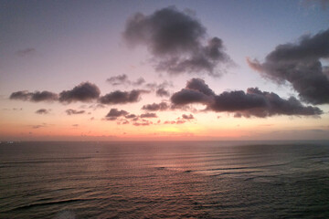 Beautiful red orange sunset sunrise over the ocean sea with waves 
