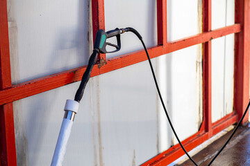 hand gun with self-service car wash close-up