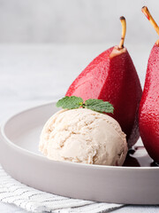 Composition with sweet poached pears and ice cream on light background