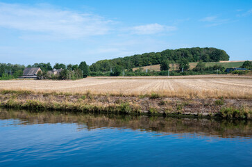 Fototapeta na wymiar View over the River Sambre, agriculture fields and farmhouses, Belgium