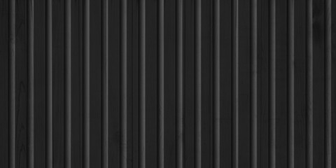 Vertical black siding texture, wooden, plastic or metal surface of a building or fence. Wall decoration for the facade.