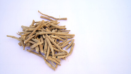 Ashwagandha Dry Root Medicinal Herb with Fresh Leaves, also known as Withania Somnifera, Ashwagandha, Indian Ginseng, Poison Gooseberry, or Winter Cherry. 