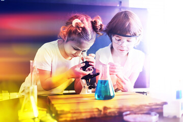 Background with highlights of children of scientists. A boy and a girl are experimenting in the laboratory.