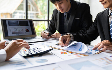 The business team that operates on the table checking data, Concept financial transactions online of a businessman, Financier being checked about financial transactions past computer with teamwork.