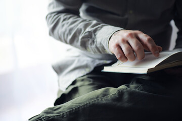 Read book. A man sits and reads literature. Textbooks to study. Religion.