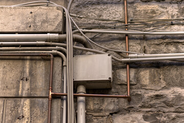 Various cable connections for electricity and telephone on the facade.