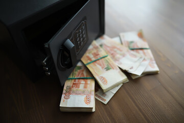 money in a residential safe close-up photo. Deposit in cash. Russian rubles are in the safe
