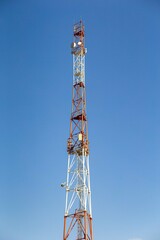 telecommunications tower with antennas against the blue sky