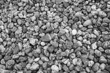 Black and white image of pebbles on the beach
