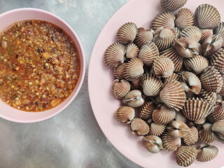 Tegillarca granosa or also known as a cockle , Blood clam. Close Up Shot. After Cooked. With Thai Spicy Seafood Sauce. Popular Thai Food.