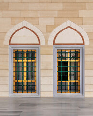 Two adjacent wrought iron arched windows with modern architectural design at the courtyard of Camlica Mosque, Istanbul, Turkey