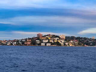 Sydney Harbour Australia at Sunset, lovely coloured skies boats ferries cruise liners houses and buildings 