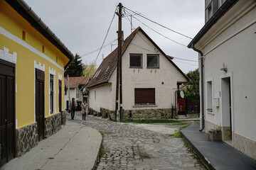 a quiet street with people and an electric pole in Szentendre, Hungary