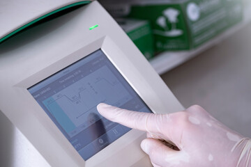 Scientist setup PCR machine, Real-time PCR for identification of pathogen, bacteria, virus including Covid19.	