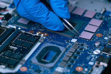 Technician repairing inside of thermal pad for Integrated Circuit. the concept of data, hardware repairing, upgrade technology.