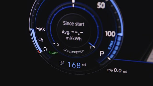 Close up of electric car dashboard display. The battery indicator shows it fills up to 168 mi. Electric Car Concept. Battery indicator showing an increasing battery charge. Electric Car Battery Gauge.