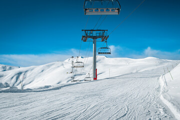 Empty ski lifts on the snowy slopes, La Toussuire, France - 531399618