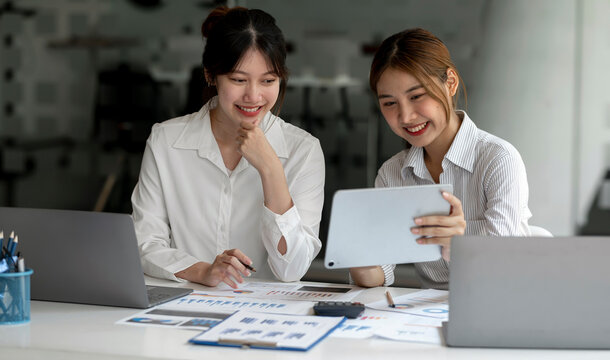 Two Young Asian businesswoman discuss with new startup project Idea presentation, analyze planning and financial