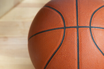 Basketball ball close-up on a wooden parquet. Sports background.