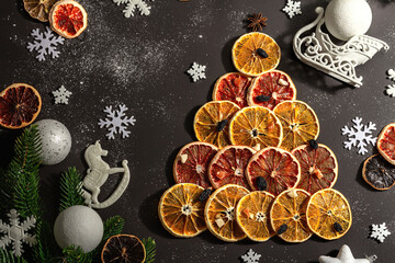 Festive fir tree from dried fruits. Christmas or New Year festive flat lay, food creative