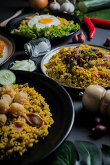Close Up Traditional Fried Rice or Nasi Goreng Indonesian Food on Black Plate with Top View Isolated Background