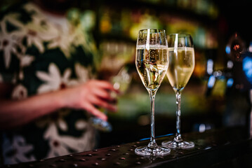 Two glasses of cold dry white champagne wine on bar
