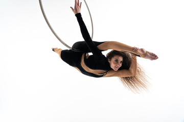 Slim and flexible woman, circus artist In aerial hoop isolated On White Background. Concept of...