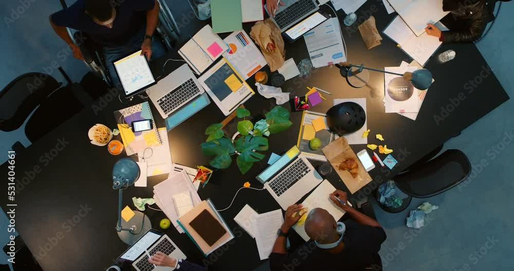 Aufkleber marketing and advertising team planning in a meeting at night from above in an office. company worke