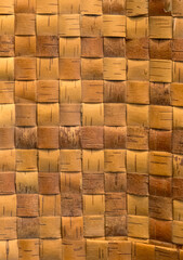 Wicker background from birch bark strips. Natural material. Texture of inner layers of birch bark of different colors with pattern of dark stripe