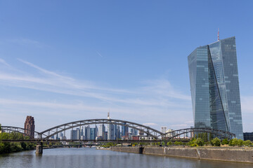 Naklejka premium Deutschherrn bridge over the Main river in Frankfurt, Germany, during daytime with the city skyline in the background