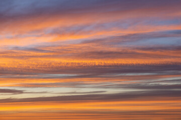 Fototapeta na wymiar Orange lit clouds during sunset