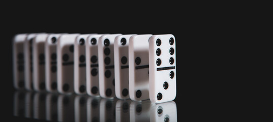 White dominoes in the dark close up