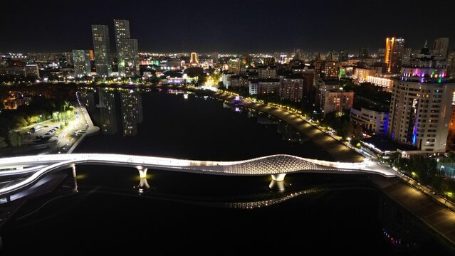 Aerial View Of A Bridge Connecting The Urban City Coasts At Night In Nur-Sultan