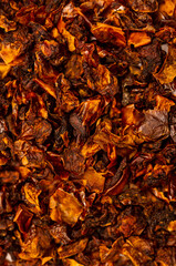 Dried and sun dried tomatoes closeup, flat lay background. Indian and Arabic spices for cooking. Medicinal herbs and condiment.