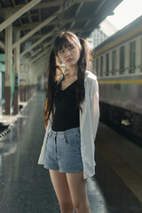 Portrait of thai japan adult beautiful girl white shirt blue jeans relax time, train station fashion