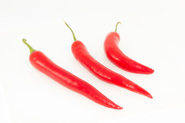 3 red hot natural chili peppers. Fresh organic  chili pepper isolated on white.