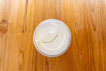 Iced honey lemon drink put in a plastic glass, top view photo and put on the dining table with a beautiful brown wooden texture