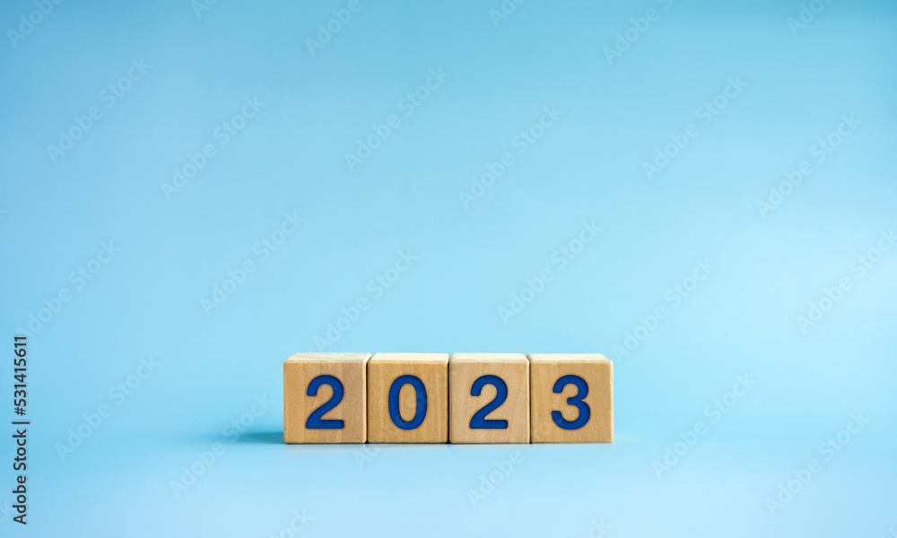Poster 2023 happy new year background banner. two thousand twenty-three year numbers on wooden cube blocks 