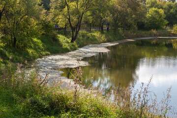 Lake in the city park, autumn, reflection in the water, beautiful buildings.