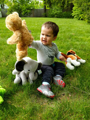 Little Child Playing with Stuffed Animals 