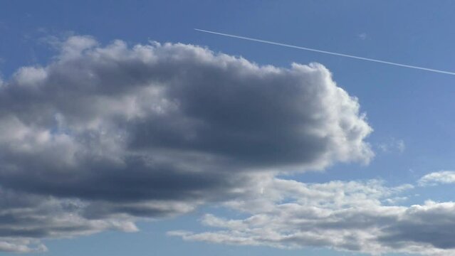 A jet plane is flying high in the clouds. Take-off of a military supersonic aircraft.