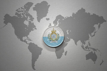 euro coin with national flag of san marino on the gray world map background.3d illustration.