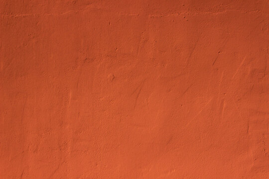 Dark brownish terracotta plaster rough wall texture background	