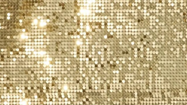 rows of blinking golden yellow brass metal plaques sway in wind and shines in sun and create unique pattern of movement. round reflective particles texture glitter under waves of wind. Spangle Glitter